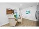 Bright dining area with a glass table, four chairs, and an opening to the living room at 3927 Spence Ave, Tampa, FL 33614
