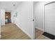 Hallway with wood-look floors and an entrance to a bright living space at 3927 Spence Ave, Tampa, FL 33614