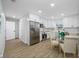 Modern kitchen featuring white cabinets, stainless steel appliances, and an adjacent dining area at 3927 Spence Ave, Tampa, FL 33614