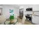 Modern kitchen with white cabinetry, stainless steel appliances, and a dining nook at 3927 Spence Ave, Tampa, FL 33614