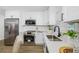 Updated kitchen with stainless appliances, white cabinets, quartz counters and subway tile backsplash at 3927 Spence Ave, Tampa, FL 33614