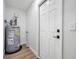 Utility room featuring a hot water tank and white door at 3927 Spence Ave, Tampa, FL 33614