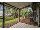 View of patio featuring tiled floors and a green and lush backyard at 39650 Us Highway 19 N # 143, Tarpon Springs, FL 34689