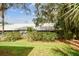 Lush, green backyard with trees and plenty of shade at 39650 Us Highway 19 N # 143, Tarpon Springs, FL 34689