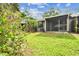 Manicured backyard with plenty of green space, bushes, and trees at 39650 Us Highway 19 N # 143, Tarpon Springs, FL 34689