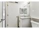 Bright bathroom featuring a granite countertop vanity, toilet, and white door at 39650 Us Highway 19 N # 143, Tarpon Springs, FL 34689