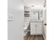 Bathroom with a granite countertop, white cabinets, shelves, mirror, and toilet at 39650 Us Highway 19 N # 143, Tarpon Springs, FL 34689