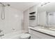 Bathroom featuring a tub-shower, granite countertop vanity, toilet, and dark wood shelving at 39650 Us Highway 19 N # 143, Tarpon Springs, FL 34689