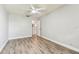 Bright bedroom with laminate flooring, ceiling fan, and neutral wall color at 39650 Us Highway 19 N # 143, Tarpon Springs, FL 34689
