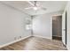 Bright, airy bedroom with wood-look floors and window at 39650 Us Highway 19 N # 143, Tarpon Springs, FL 34689