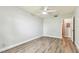 This bright bedroom has vinyl flooring and access to other parts of the home at 39650 Us Highway 19 N # 143, Tarpon Springs, FL 34689