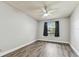 Bright bedroom with laminate flooring, ceiling fan, and a window with a palm tree view at 39650 Us Highway 19 N # 143, Tarpon Springs, FL 34689