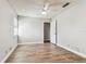 Bright, airy bedroom with wood-look floors, ceiling fan, and closet at 39650 Us Highway 19 N # 143, Tarpon Springs, FL 34689