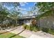 Single-story home with well-maintained front yard and charming walkway at 39650 Us Highway 19 N # 143, Tarpon Springs, FL 34689