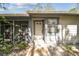 Charming single-story home with inviting entrance, side patio, and well-maintained landscaping at 39650 Us Highway 19 N # 143, Tarpon Springs, FL 34689