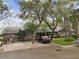 Home with mature trees in the front yard and well-kept landscaping at 39650 Us Highway 19 N # 143, Tarpon Springs, FL 34689