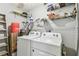 Functional laundry room featuring a washer, dryer, shelves and storage at 39650 Us Highway 19 N # 143, Tarpon Springs, FL 34689