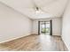 The living room has laminate flooring and a glass sliding door to the outdoors at 39650 Us Highway 19 N # 143, Tarpon Springs, FL 34689