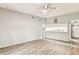 Bright living room with ceiling fan, laminate flooring, and an open layout to the kitchen at 39650 Us Highway 19 N # 143, Tarpon Springs, FL 34689