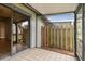Tiled screened patio that shows entry to living room and side yard at 39650 Us Highway 19 N # 143, Tarpon Springs, FL 34689
