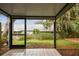 Tiled screened patio offers a tranquil view of the lush, green backyard at 39650 Us Highway 19 N # 143, Tarpon Springs, FL 34689