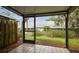 The screened patio features tile floors and a view of the backyard at 39650 Us Highway 19 N # 143, Tarpon Springs, FL 34689