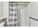 Clean white shower stall with striped curtain and handrail in bathroom at 39650 Us Highway 19 N # 143, Tarpon Springs, FL 34689