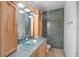 Modern bathroom featuring double sinks, wood cabinetry, mosaic tile accent wall and tile floors at 400 4Th S Ave # 508, St Petersburg, FL 33701