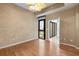 Bedroom showcasing a ceiling fan, hardwood floors, and balcony access at 400 4Th S Ave # 508, St Petersburg, FL 33701