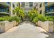 Inviting condominium building entrance with lush tropical landscaping and water feature at 400 4Th S Ave # 508, St Petersburg, FL 33701