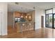 Modern kitchen featuring breakfast bar with seating, pendant lighting, and wooden cabinets at 400 4Th S Ave # 508, St Petersburg, FL 33701