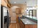 Gourmet kitchen sink features modern fixtures, stone countertops, and wooden cabinetry at 400 4Th S Ave # 508, St Petersburg, FL 33701