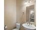 Stylish powder room featuring a pedestal sink, elongated toilet, and textured walls at 400 4Th S Ave # 508, St Petersburg, FL 33701