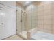 Bathroom shower showcasing tile walls, glass door and a soaking tub at 400 4Th S Ave # 508, St Petersburg, FL 33701