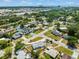An aerial view shows the neighborhood with green trees surrounding single-Gathering homes and commercial area in the distance at 4005 W Coachman Ave, Tampa, FL 33611