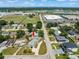 An aerial view shows the neighborhood with green trees surrounding single-Gathering homes and commercial area in the distance at 4005 W Coachman Ave, Tampa, FL 33611
