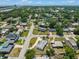 An aerial view shows the neighborhood with green trees surrounding single-Gathering homes and a waterway in the distance at 4005 W Coachman Ave, Tampa, FL 33611