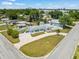 Aerial view of a charming home with a paved driveway, fenced yard, and lush landscaping at 4005 W Coachman Ave, Tampa, FL 33611