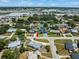 An aerial view shows the neighborhood with green trees surrounding single-Gathering homes and commercial area in the distance at 4005 W Coachman Ave, Tampa, FL 33611