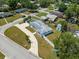 Charming single-story home featuring a brick driveway, lush lawn, and white picket fence at 4005 W Coachman Ave, Tampa, FL 33611