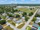Charming neighborhood aerial view with lush trees and distant city skyline on a sunny day at 4005 W Coachman Ave, Tampa, FL 33611