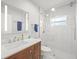 Modern bathroom with glass shower, vanity with storage, and large mirror providing a clean aesthetic at 4005 W Coachman Ave, Tampa, FL 33611