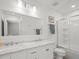 Well-lit bathroom boasts a double vanity, framed mirror, and a glass-enclosed shower at 4005 W Coachman Ave, Tampa, FL 33611
