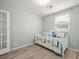 Bright bedroom featuring wood floors, large window, and a brightly patterned daybed at 4005 W Coachman Ave, Tampa, FL 33611