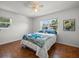 Comfortable bedroom featuring hardwood floors, ceiling fan and serene decor with ample natural light at 4005 W Coachman Ave, Tampa, FL 33611