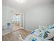 Bright bedroom featuring wood floors and view into sunroom, with brightly patterned daybed at 4005 W Coachman Ave, Tampa, FL 33611