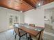Inviting dining room showcases wooden ceiling, glass insert table, comfortable seating, and access to the outdoors at 4005 W Coachman Ave, Tampa, FL 33611