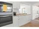 Updated kitchen featuring modern appliances, white cabinetry, granite countertops, and open design, ideal for cooking and gatherings at 4005 W Coachman Ave, Tampa, FL 33611