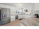 Bright kitchen featuring white cabinets, stainless steel appliances and granite countertops, perfect for cooking and entertaining at 4005 W Coachman Ave, Tampa, FL 33611