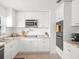 Stylish kitchen showcases white cabinets, stainless steel appliances, and granite countertops, ideal for cooking and entertaining at 4005 W Coachman Ave, Tampa, FL 33611